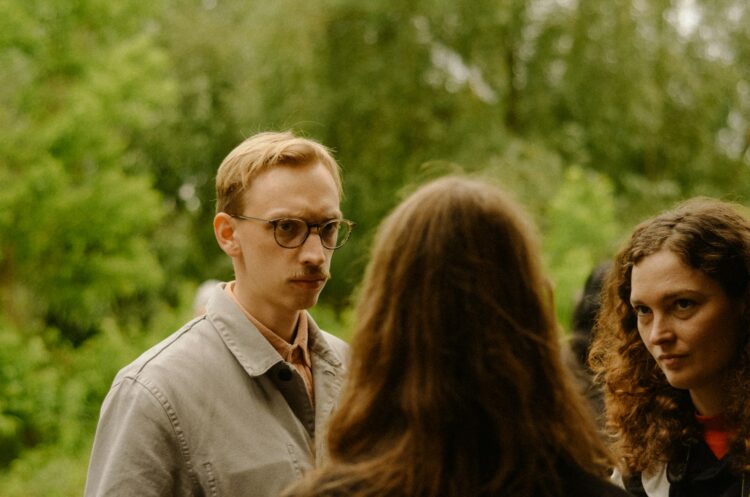 a group of people standing around each other