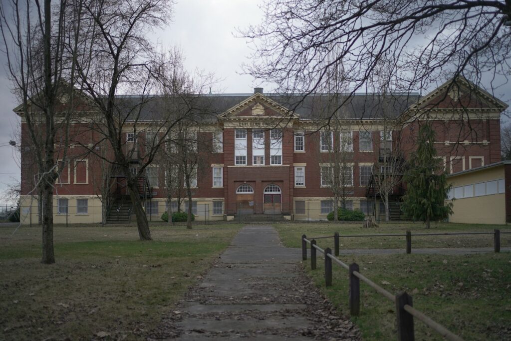 a large brick building with trees in front of it