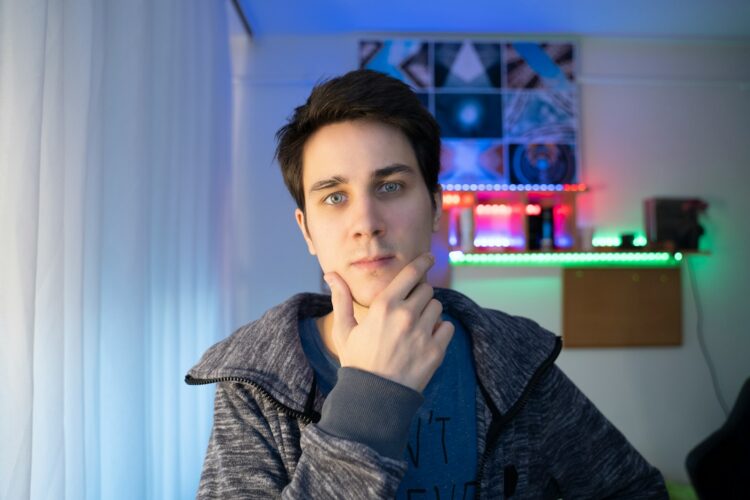 a young man is looking at the camera