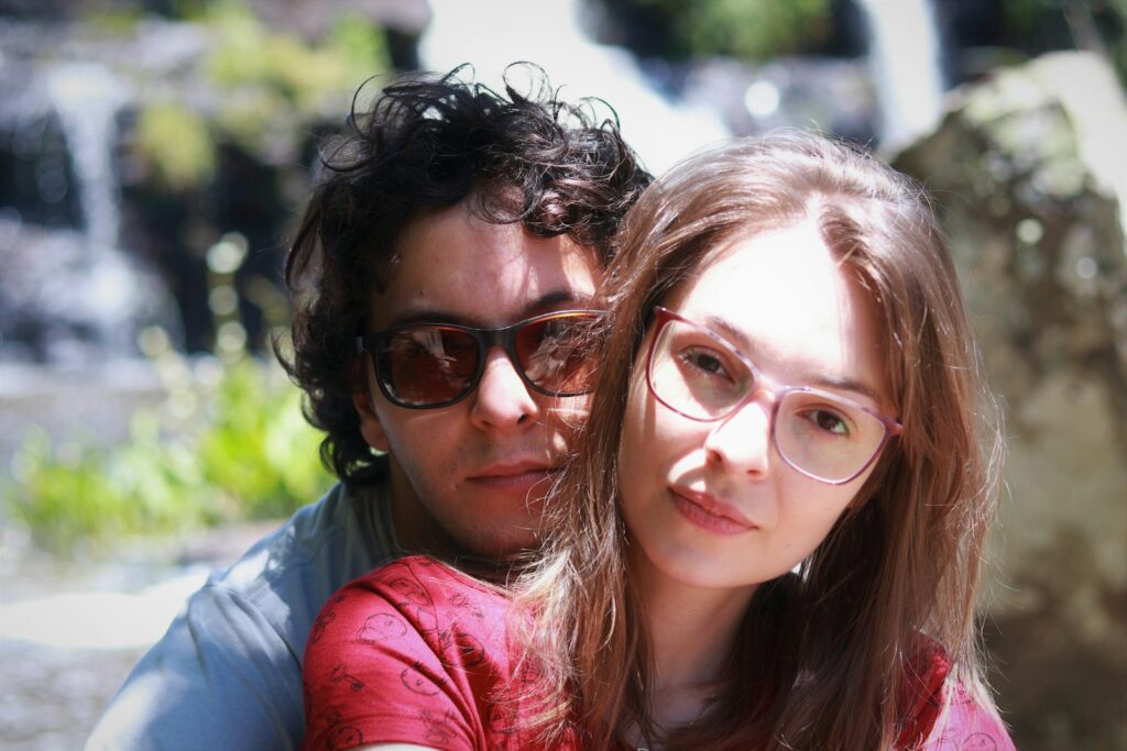woman in red leather jacket beside woman in blue shirt