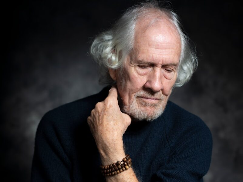 man in black long sleeve shirt sitting on chair