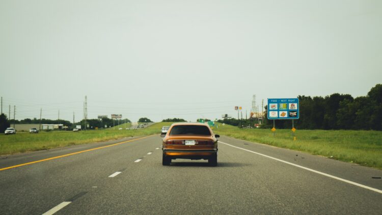 red car on road during daytime