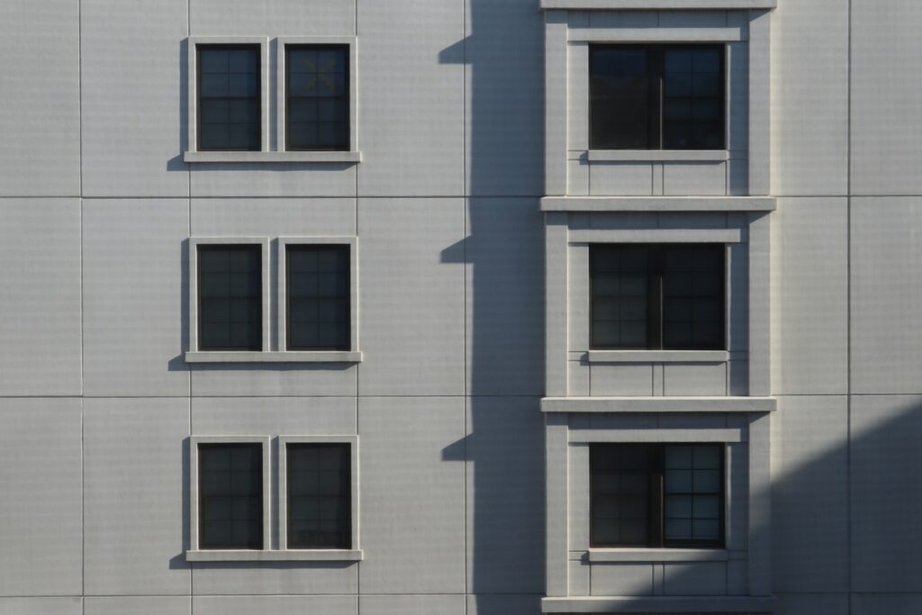 a white building with three windows and a clock