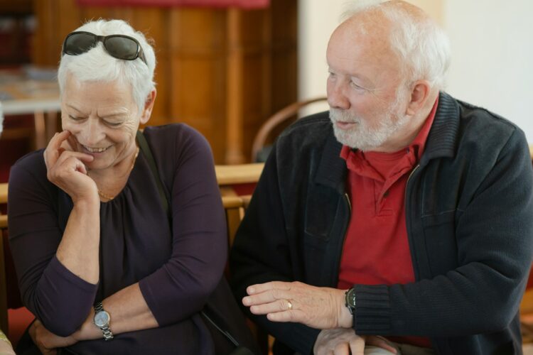 An older couple is talking and smiling.
