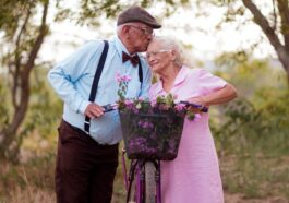 A man and a woman standing next to a bike