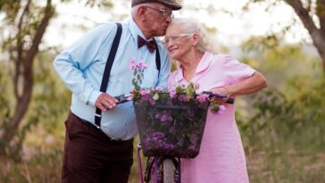 A man and a woman standing next to a bike