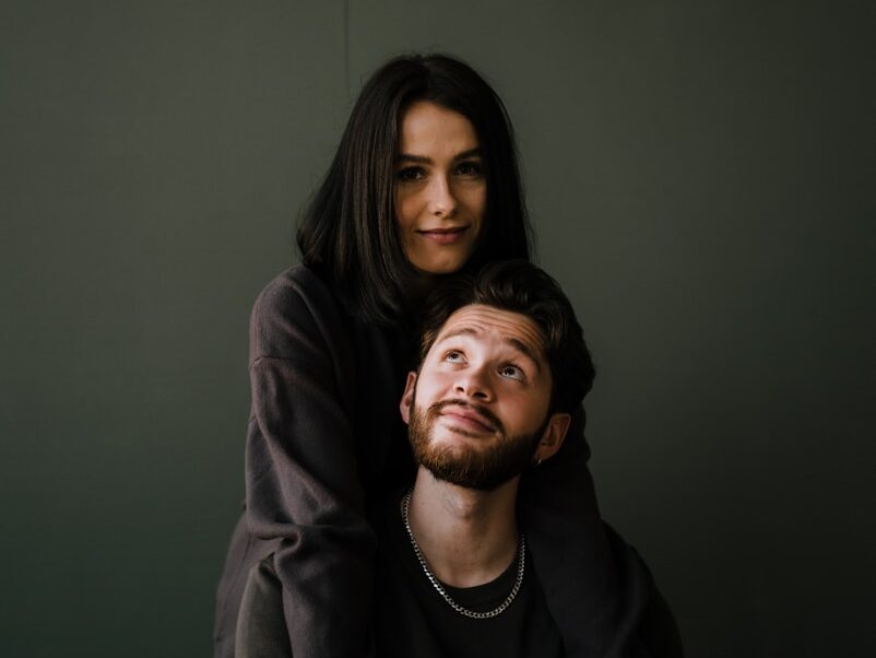 man in black crew neck shirt beside woman in black long sleeve shirt