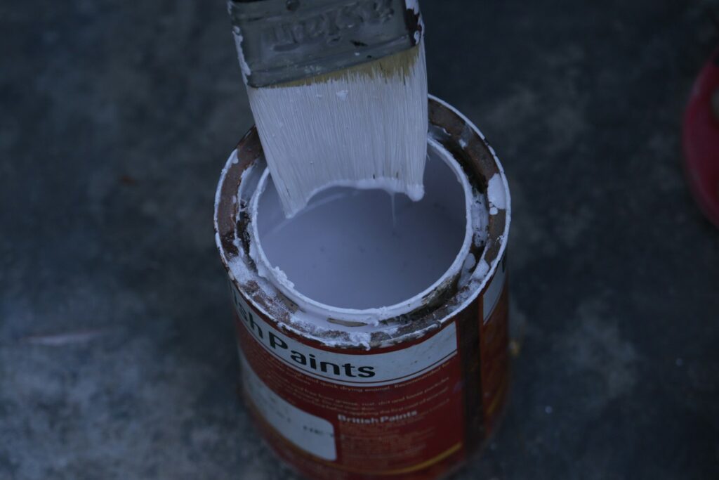 a paint can with a brush inside of it