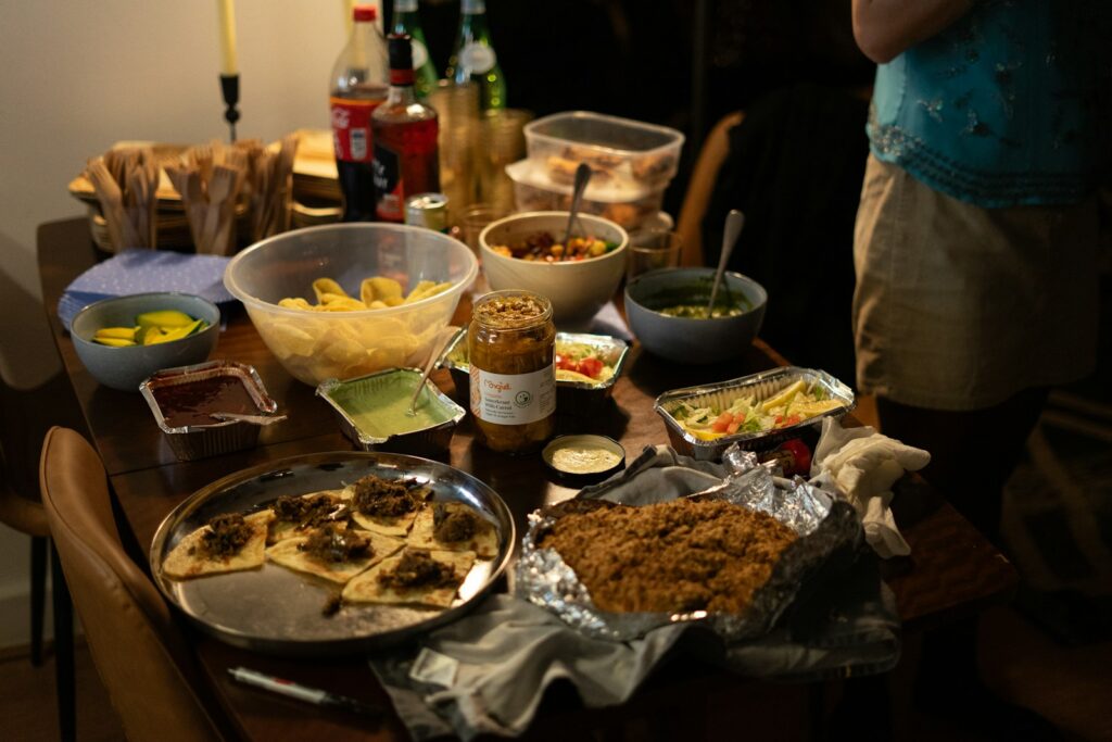 A table laden with various dishes and drinks.