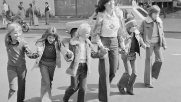 a group of young girls walking down a street