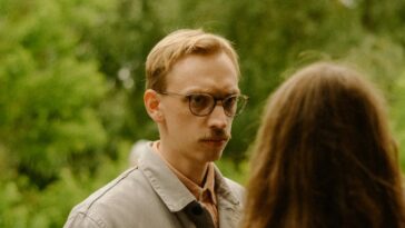 a group of people standing around each other