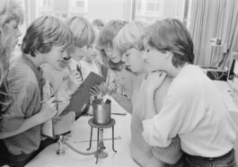 a group of young women standing around a table