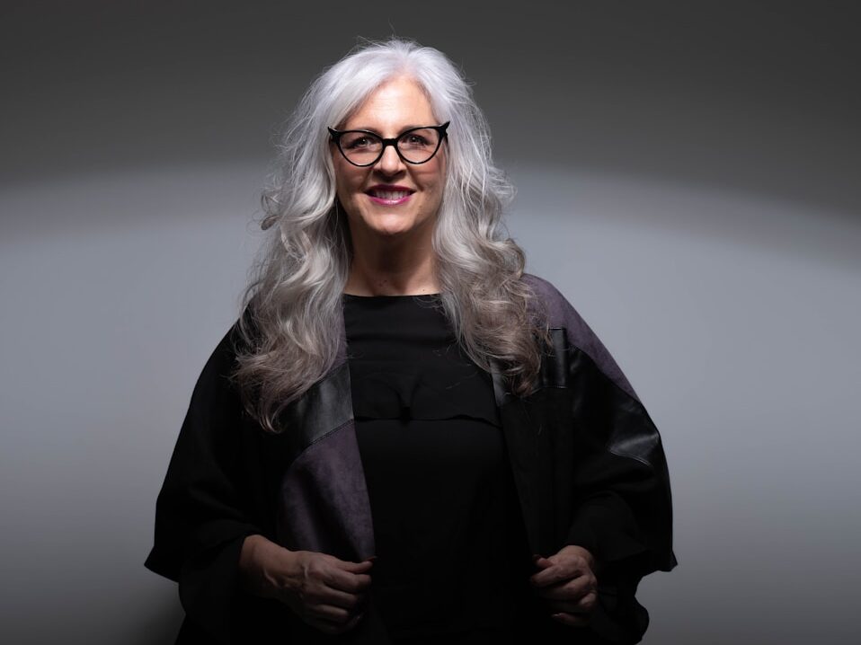 woman in black coat wearing eyeglasses