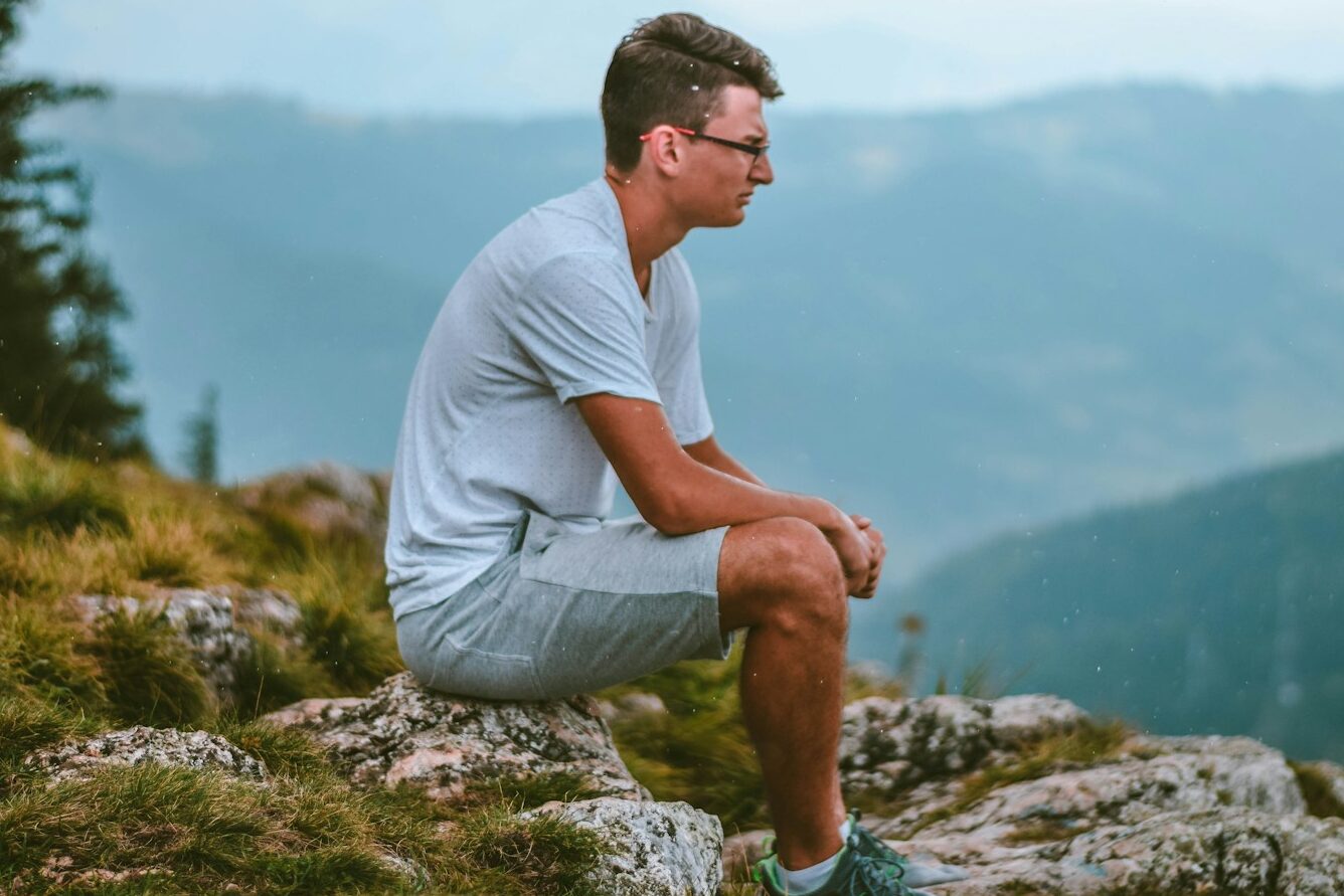 sitting man wearing white t-shirt